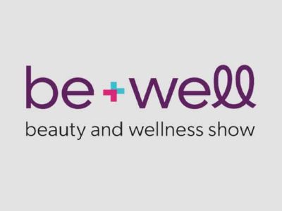 Be+Well beauty and wellness show logo on a gray background