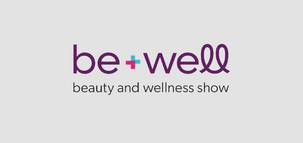 Be+Well beauty and wellness show logo on a gray background